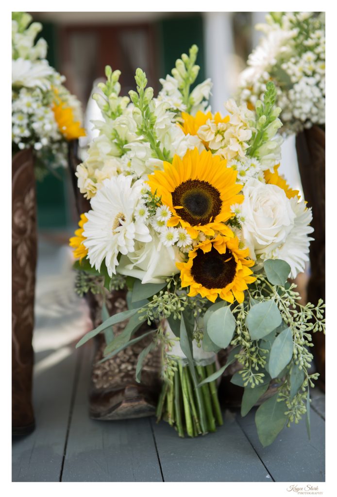 Fall Bouquet by Pine Hills Floral Design in front of brides shoes at wedding in Beauvoir