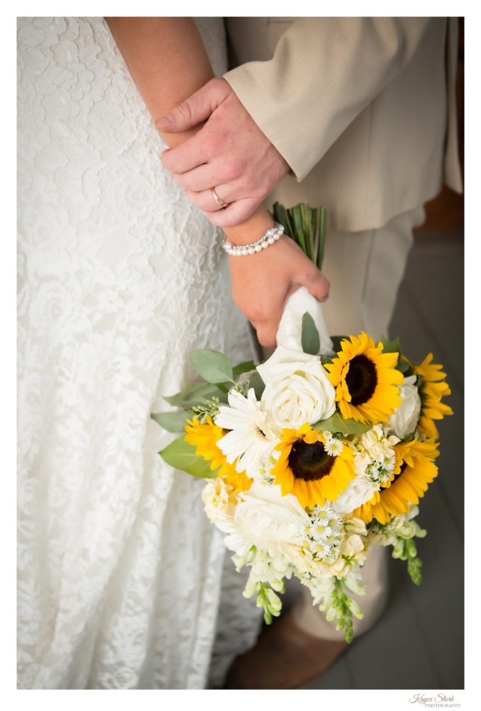 bride and groom photo with sunflower bouquet from pine hills floral design
