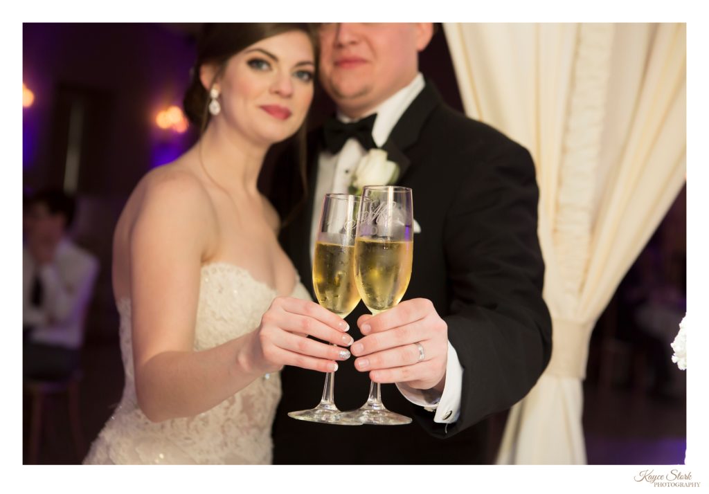 Bride and Groom toasting at wedding in Biloxi at Slavonian Lodge