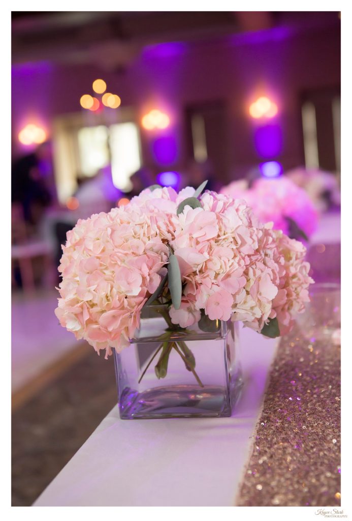 pink hydrangea with gold table runner at wedding reception