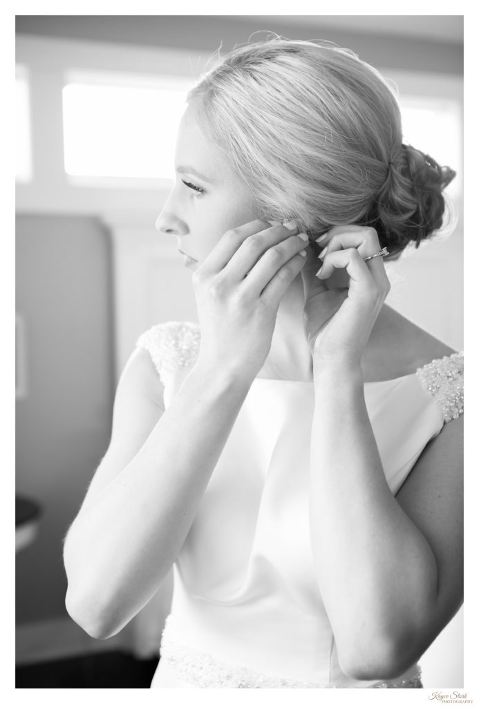 Bride putting on jewelry before her wedding in Bay St. Louis 