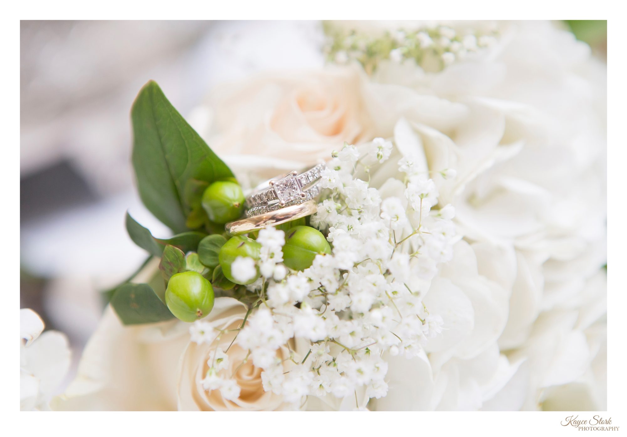 Bride and grooms wedding rings in brides bouquet by kayce stork photography