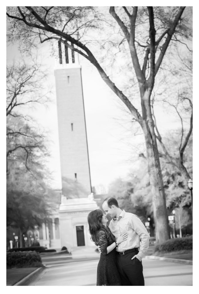 Bride and Groom stand in front of Denny Chimes for a photo during their engagement session at the university of alabama