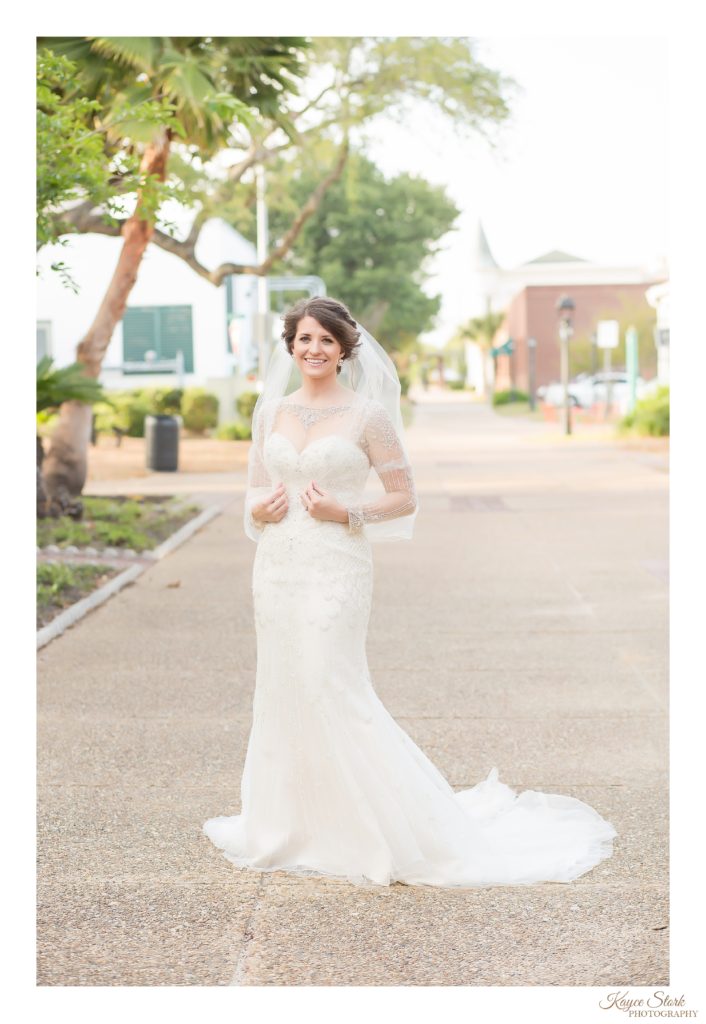 Bride in Downtown Biloxi during bridal session holding veil