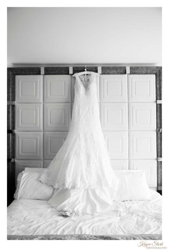 Black and white photo of wedding dress hanging on the bed at the Island View Casino Resort in Gulfport MS