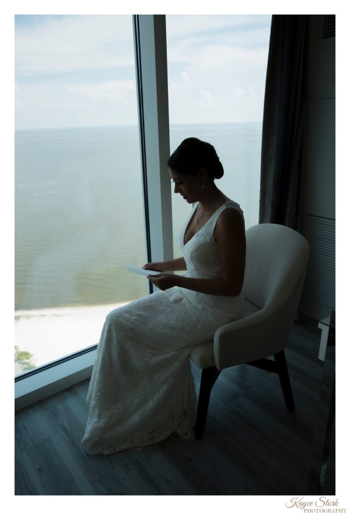 Bride reading letter from Groom before wedding at Island View Casino in Gulfport