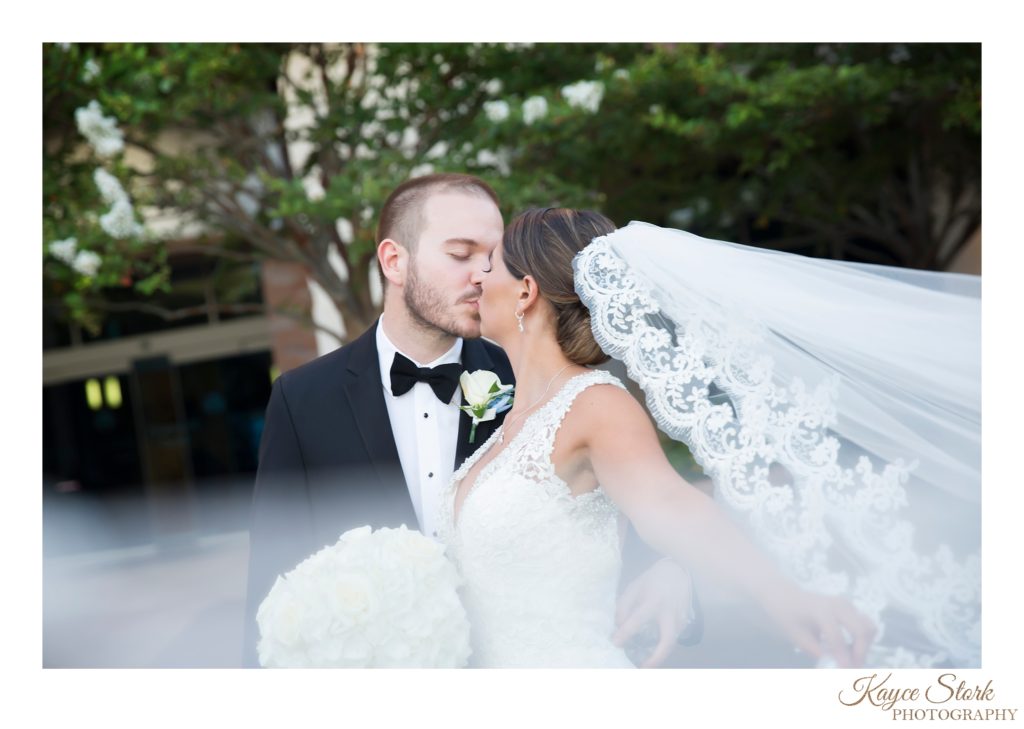 Bride and Groom share a kiss outside reception at the great southern club