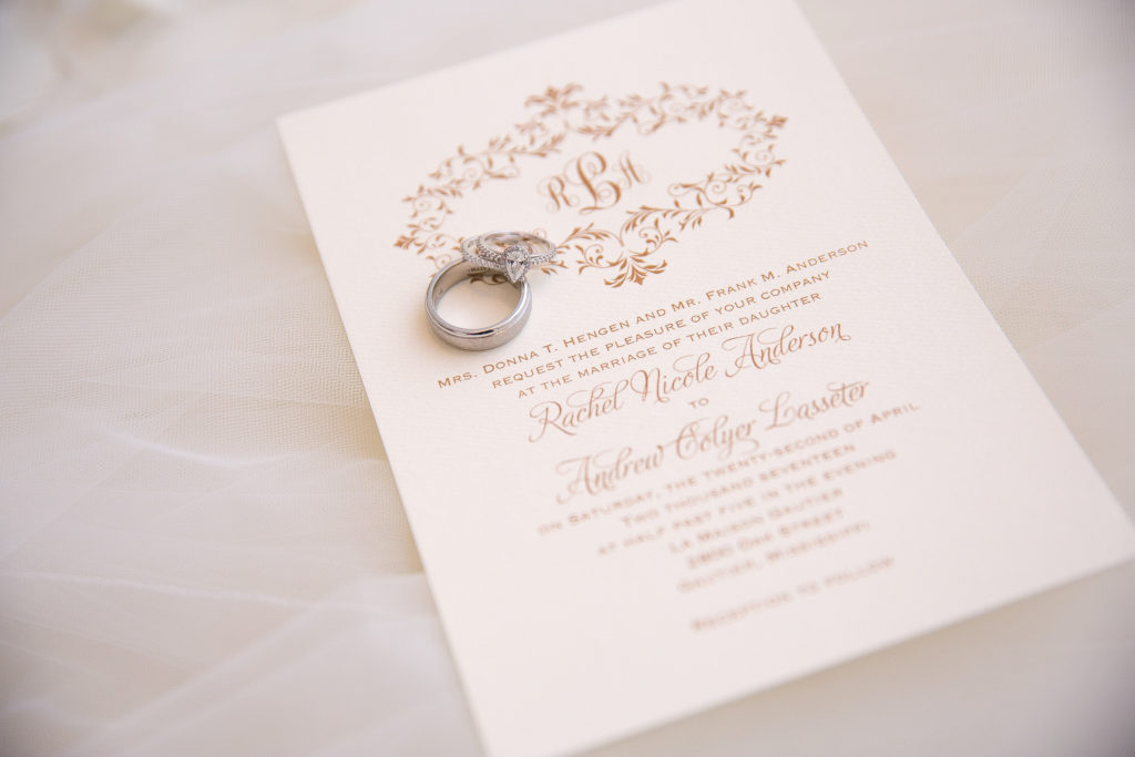 Photo of Wedding invitation with Wedding Rings on top photographed by Kayce Stork Photography